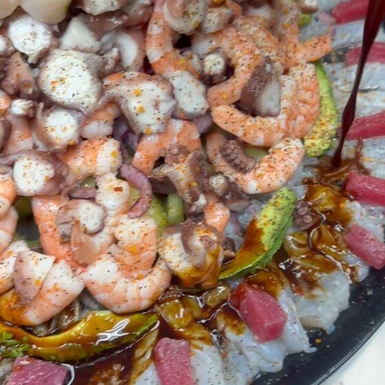 A round charola heaped with shrimp, octopus, scallops and tuna, from their Instagram